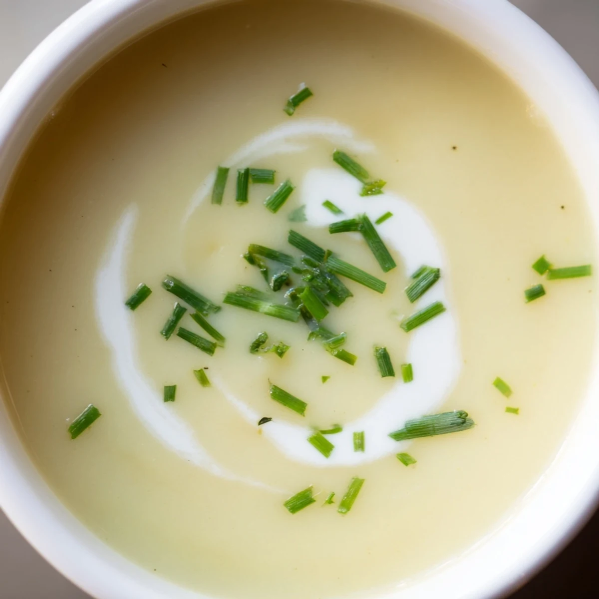A warm bowl of Creamy Leek Soup with Potatoes, featuring tender leeks and potatoes blended into a smooth texture.
