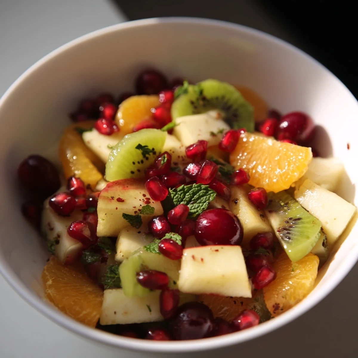 Colorful Winter Fruit Salad with Honey Lime Dressing on a serving platter, featuring diced apples, pears, grapes, and dried cranberries tossed with zesty dressing.