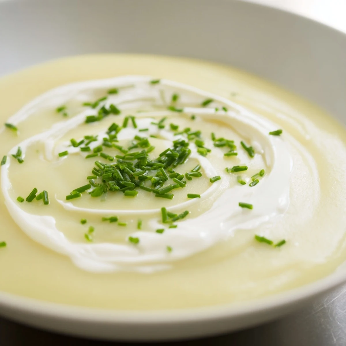 A pot of Creamy Leek Soup with Diced Potatoes simmering on the stove, featuring tender leeks and golden potatoes in velvety broth.