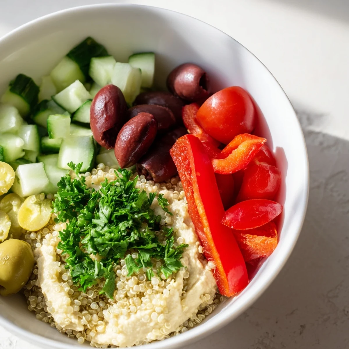 Healthy Mediterranean Quinoa Bowl served with lemon wedges and parsley, perfect for a light lunch.