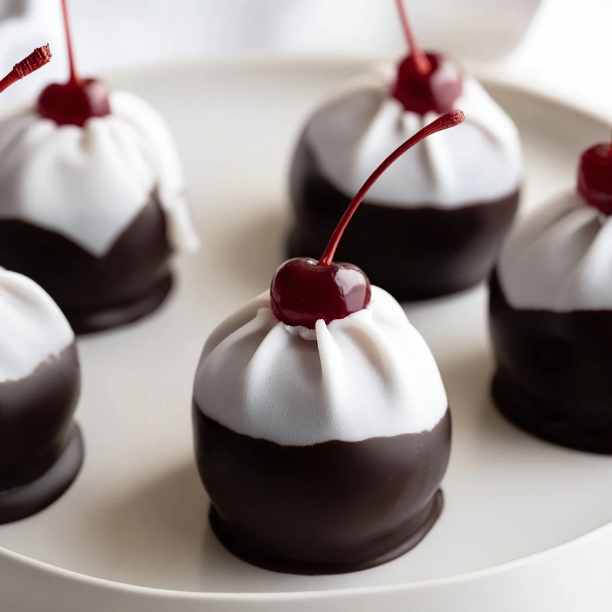 A batch of homemade chocolate covered cherries resting on parchment, ready to be gifted or served at parties.