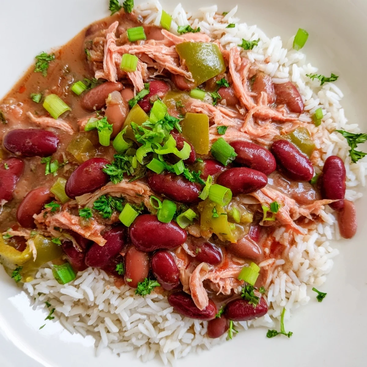 Savory Creole Red Beans and Rice with Smoked Turkey simmered in a Dutch oven, revealing aromatic spices and a rich, hearty texture.