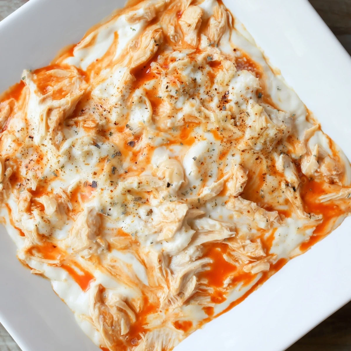Fresh celery sticks are arranged alongside the warm Spicy Buffalo Chicken Dip for dipping.  