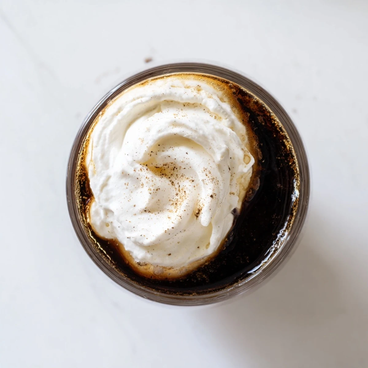 Ready-to-serve Irish Coffee Mocktail in a heatproof mug, featuring a perfect swirl of whipped cream and a dusting of cocoa.
