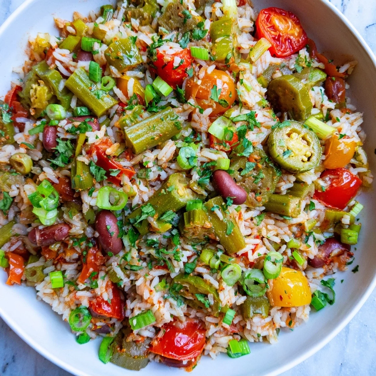 Steaming bowl of Mardi Gras Veggie Jambalaya with Cajun spices, topped with sliced green onions and a lemon wedge, perfect for a festive Louisiana-inspired dinner.
