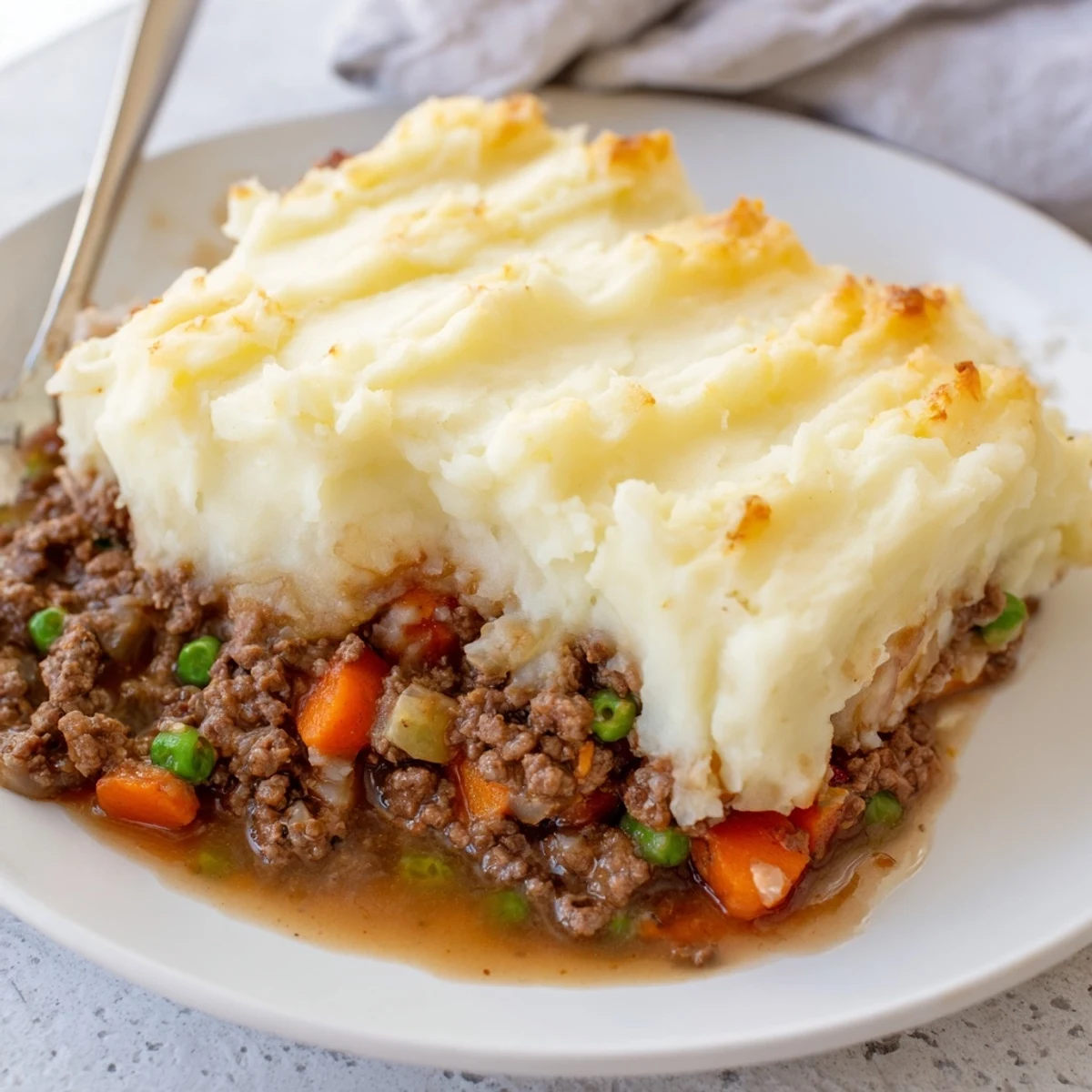 Beef Shepherds Pie with Cheddar Mash is baked to perfection, with melted cheddar topping a comforting, gravy-laden beef and vegetable filling.