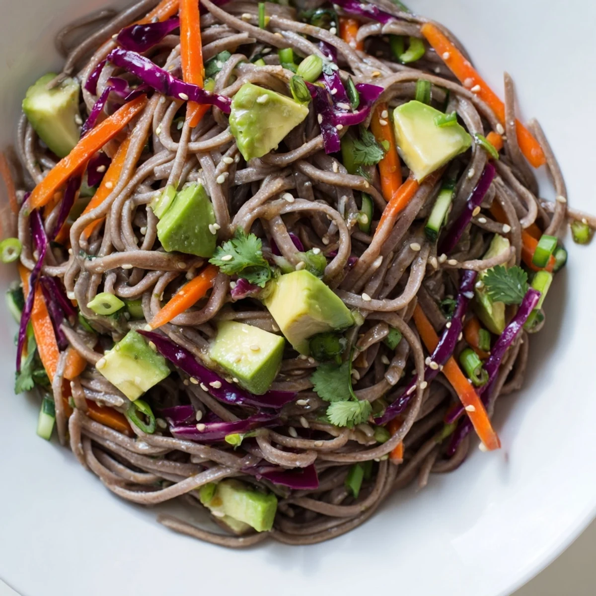 Creamy diced avocado and chilled soba noodles tossed with crisp red cabbage and carrots in a savory sesame dressing.