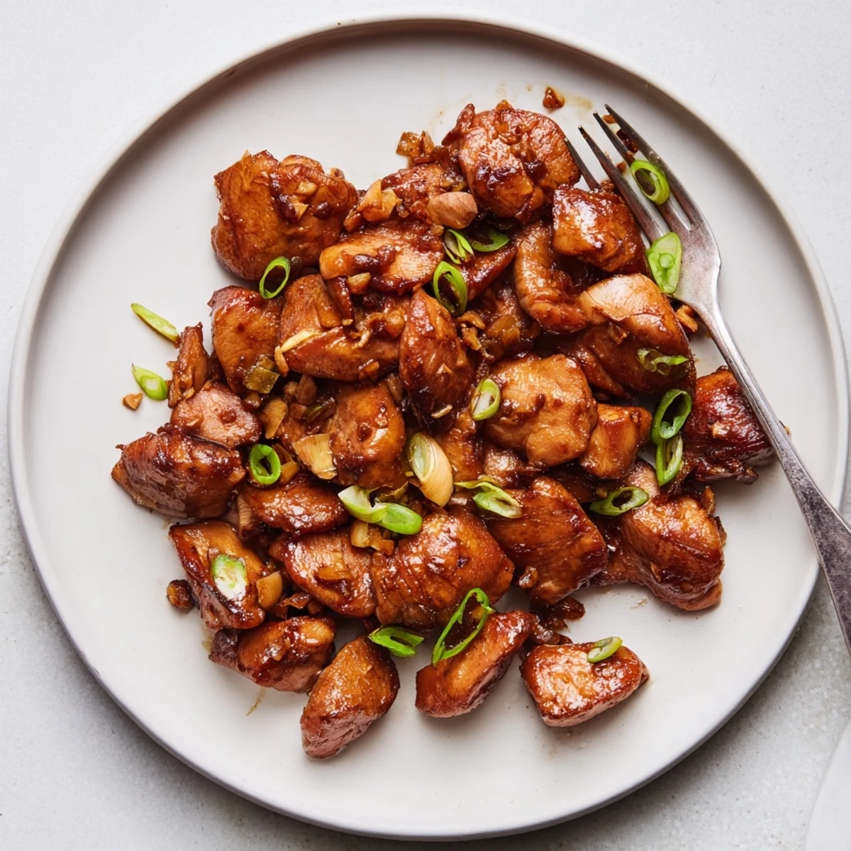 Crispy coated Mongolian chicken wok-fried until caramelized in glossy Asian-inspired sweet glaze