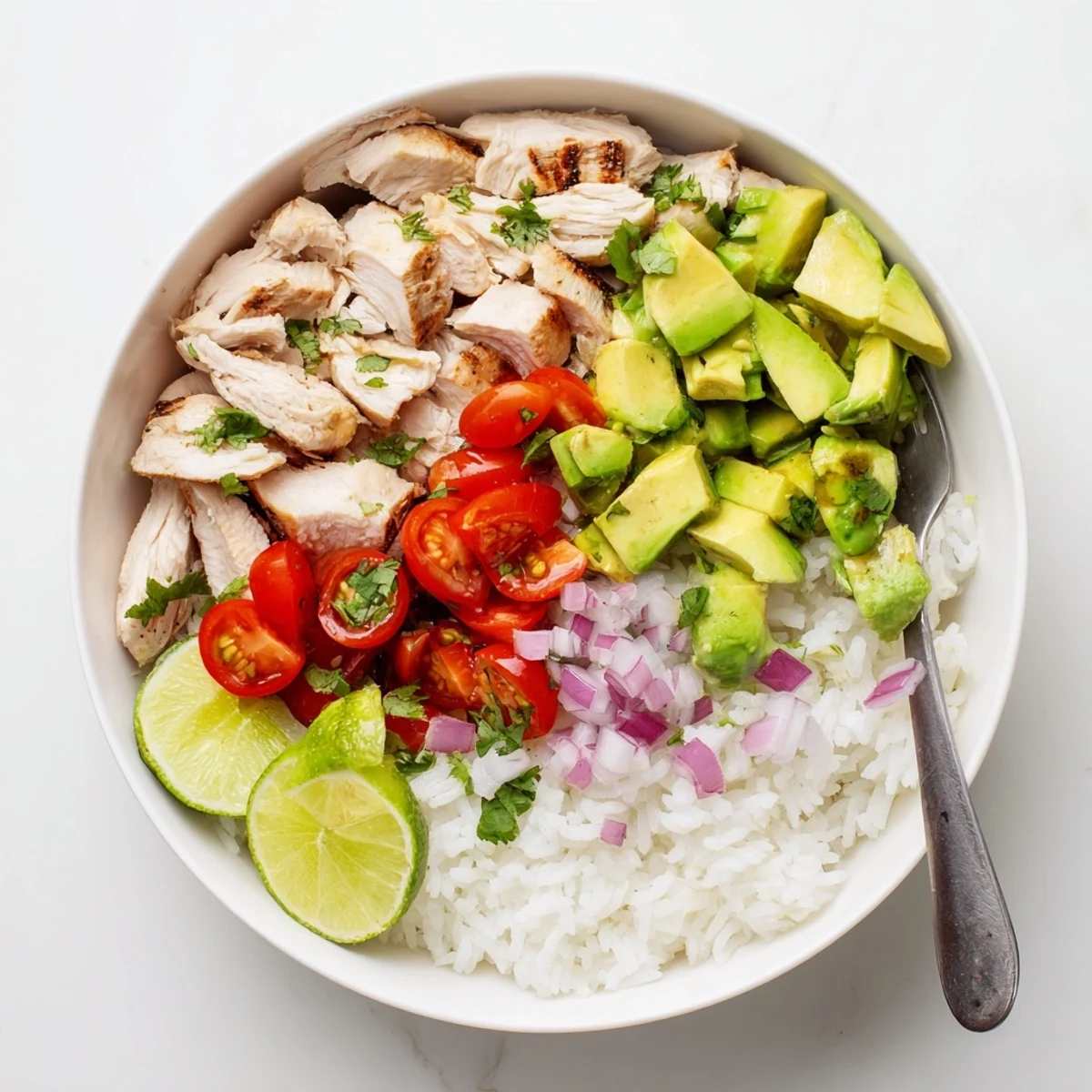 Golden honey lime chicken slices over fluffy white rice topped with creamy diced avocado