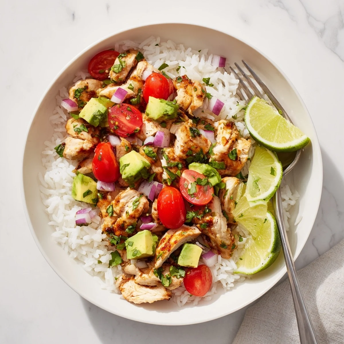 Fresh honey lime grilled chicken bowl with ripe avocado chunks and fluffy rice