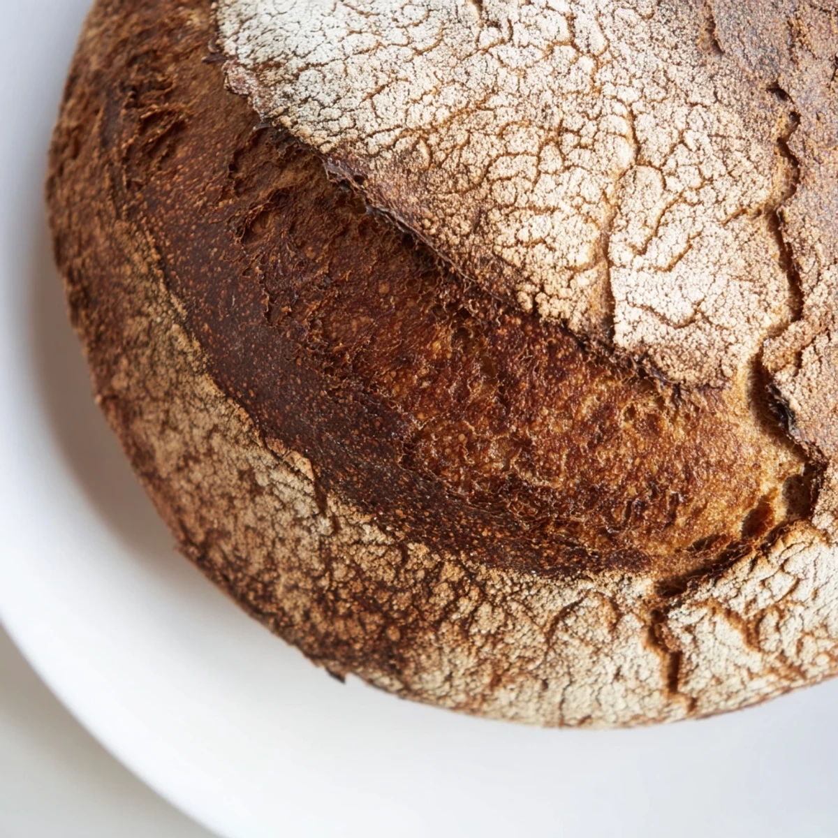 Homemade artisan no knead bread cooling on wire rack, perfect crusty texture for sandwiches