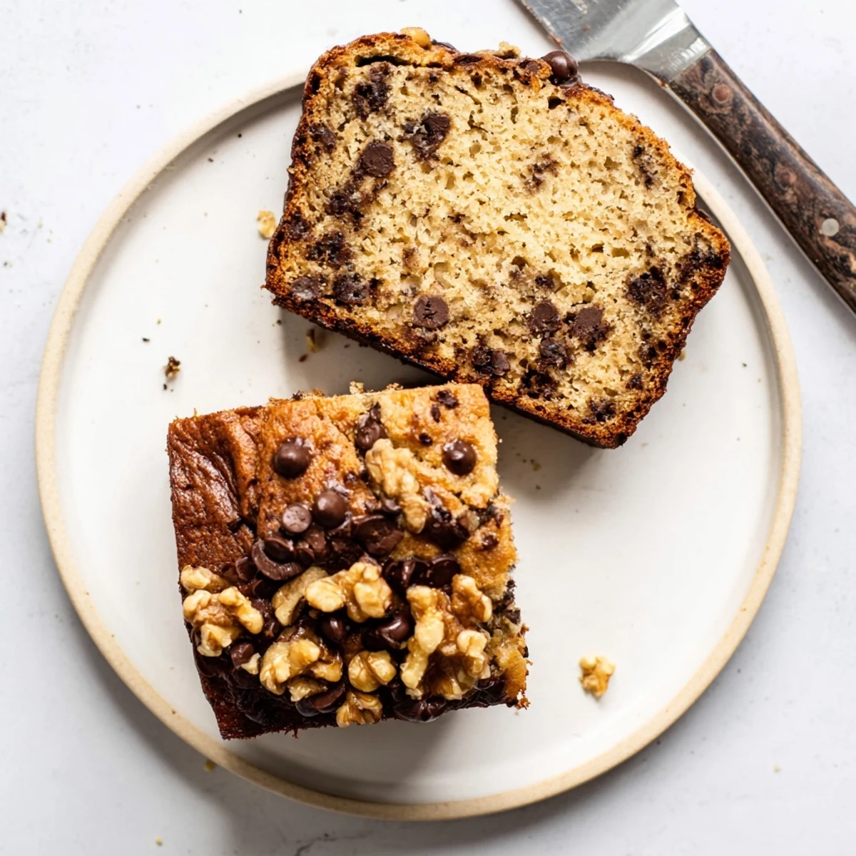 Moist chocolate chip banana bread freshly baked with semisweet chocolate chunks throughout and a golden crusty top