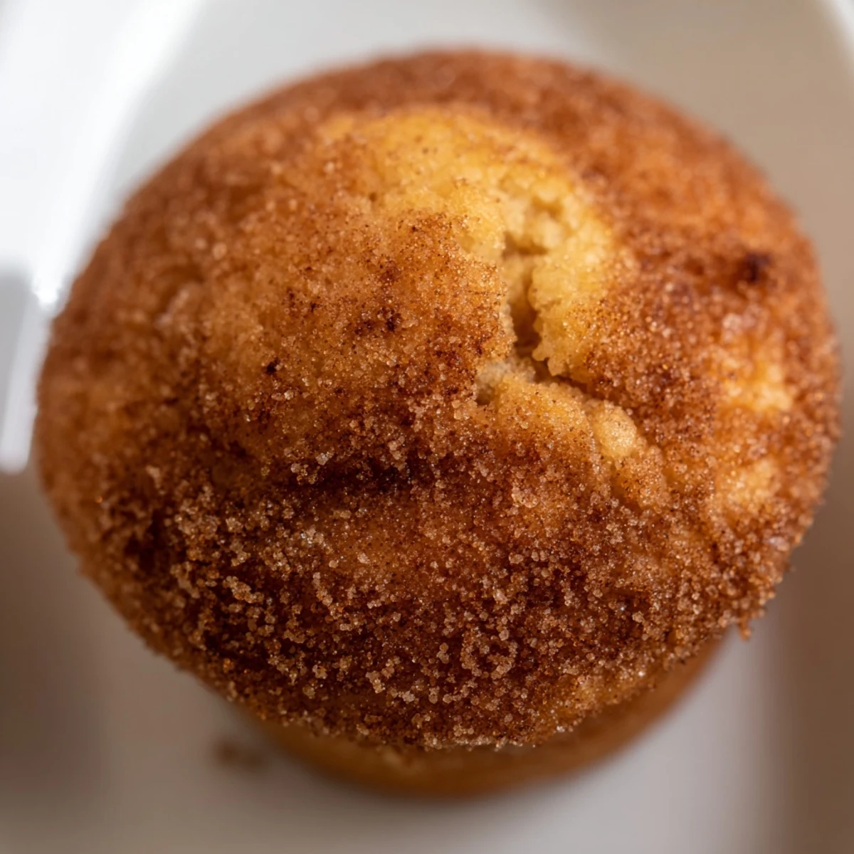 Warm easy cinnamon sugar mini muffins stacked on serving plate for breakfast