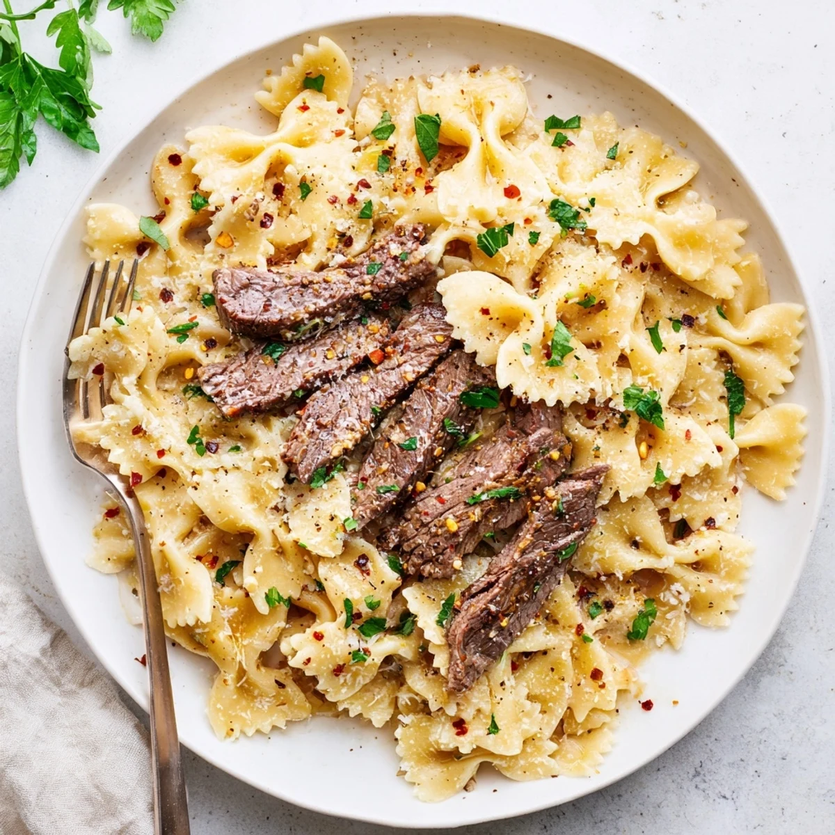 Savory Cajun-spiced beef rests over tender pasta noodles in a creamy Parmesan cheese sauce