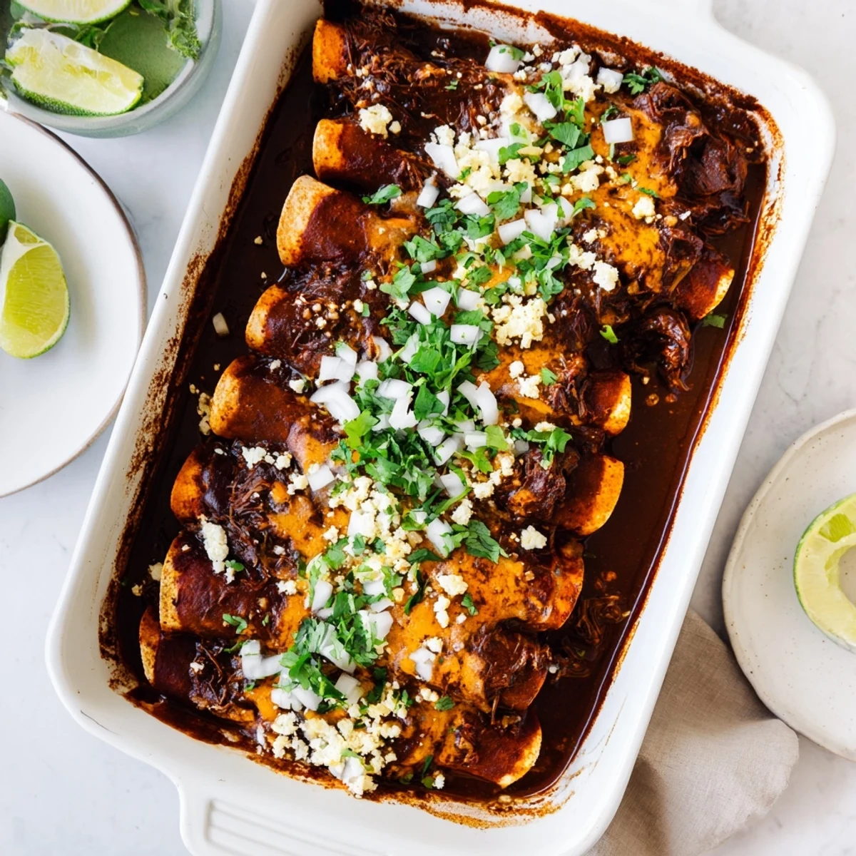 Golden corn tortillas rolled around juicy birria beef, smothered in savory sauce and bubbly cheese
