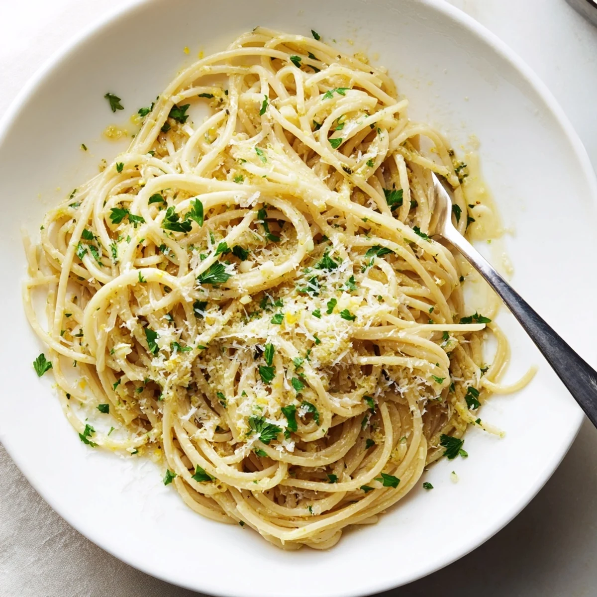 Steaming plate of garlic butter pasta featuring al dente noodles tossed in rich melted butter sauce