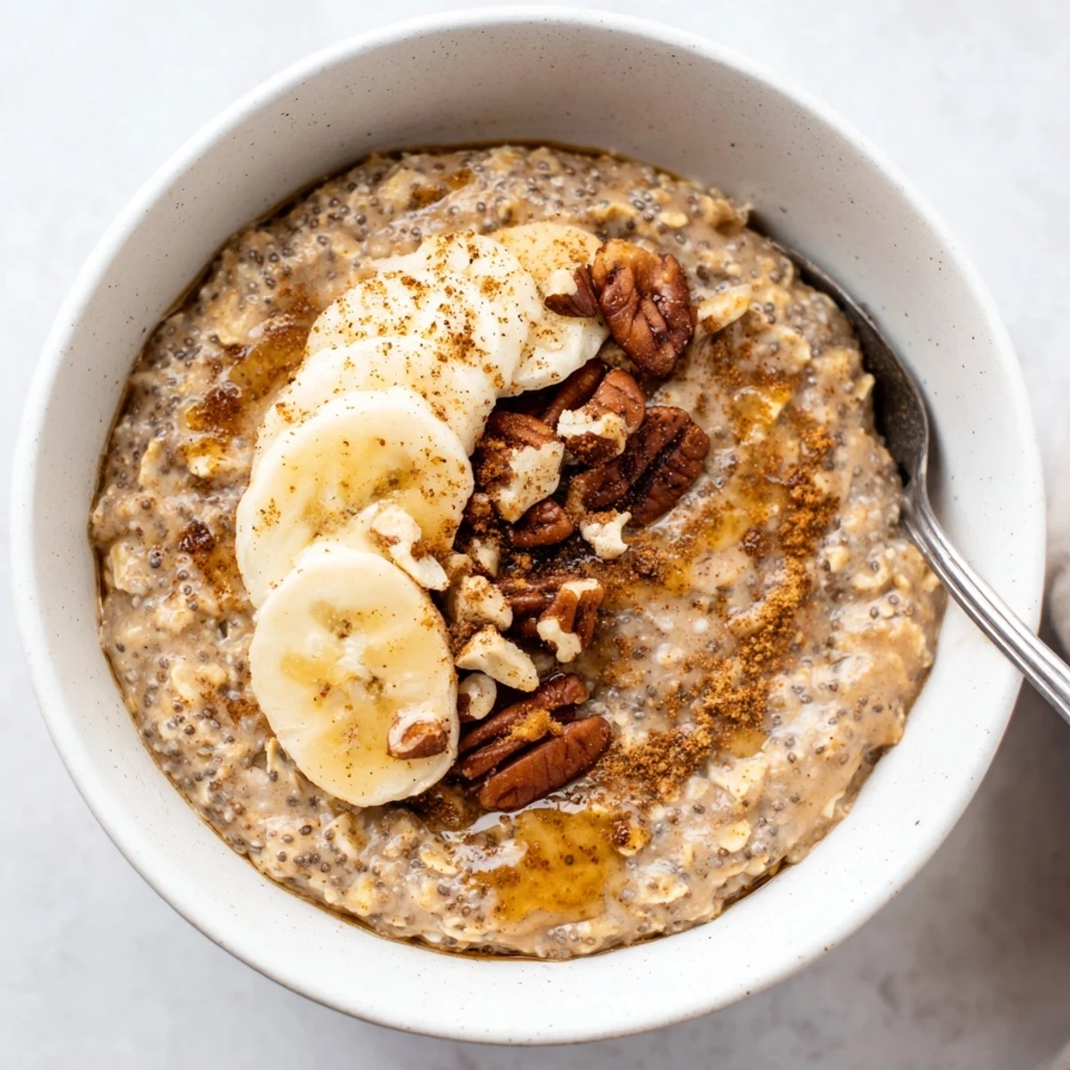 Velvety Brown Sugar Coffee Overnight Oats garnished with maple drizzle and nuts