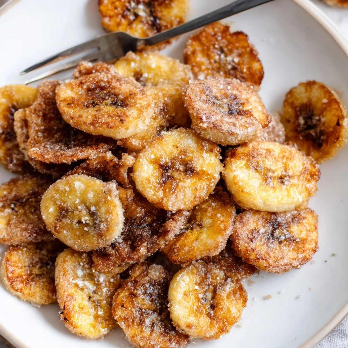 Crispy Cinnamon Sugar Air Fryer Banana Chips cooling on rack, ready for dipping.