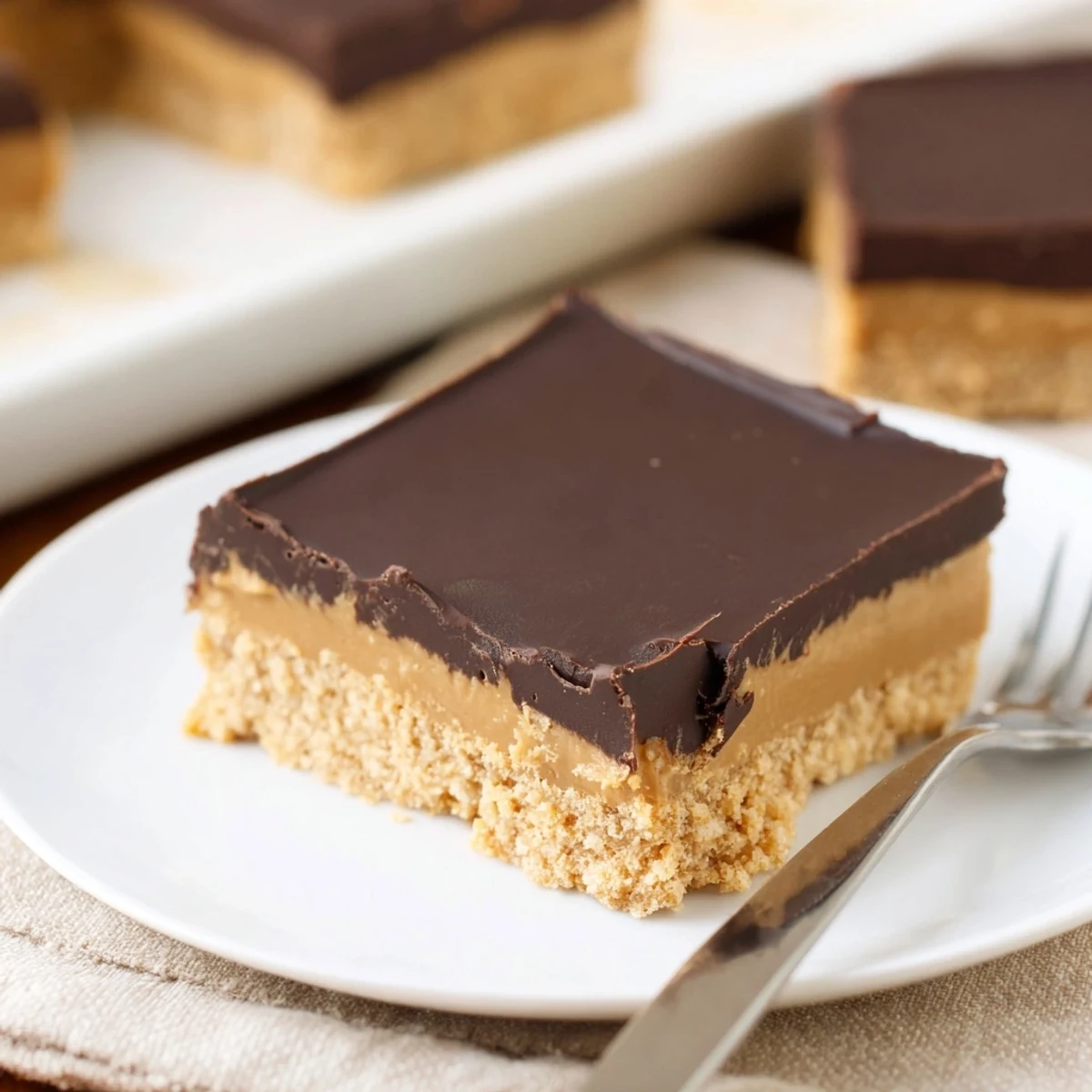 Stacked No Bake Peanut Butter Bars dusted with powdered sugar, perfect picnic dessert