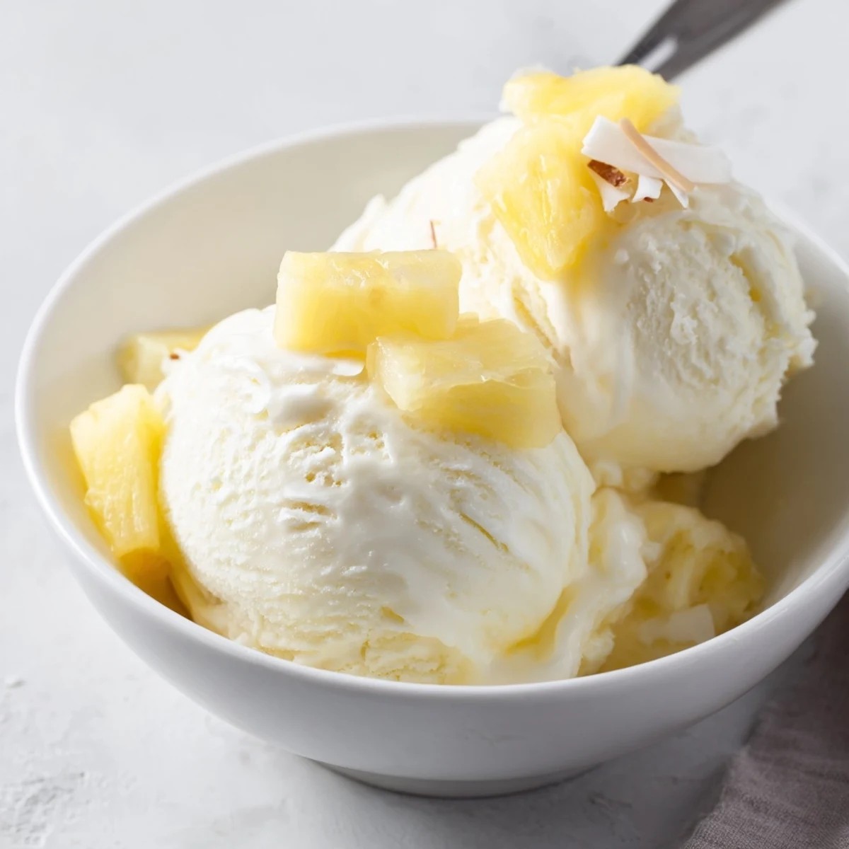 Homemade Creamy Pineapple Ice Cream with golden pineapple chunks and silky swirls