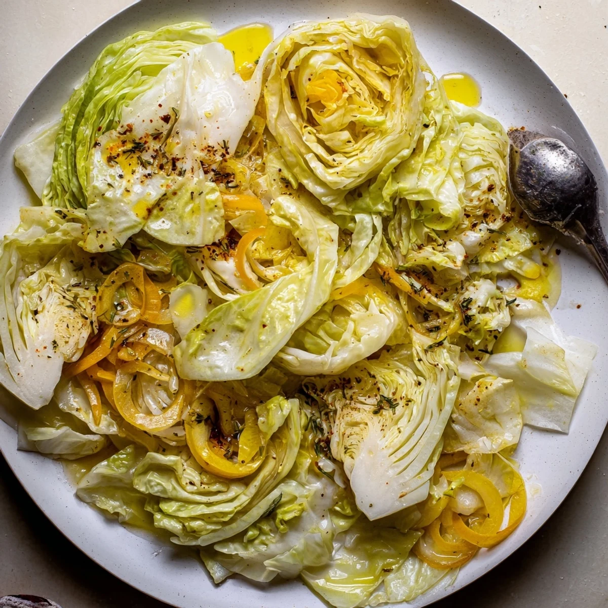 Warm, tangy slow-cooked cabbage in a rustic skillet — Savory Braised Cabbage Recipe.