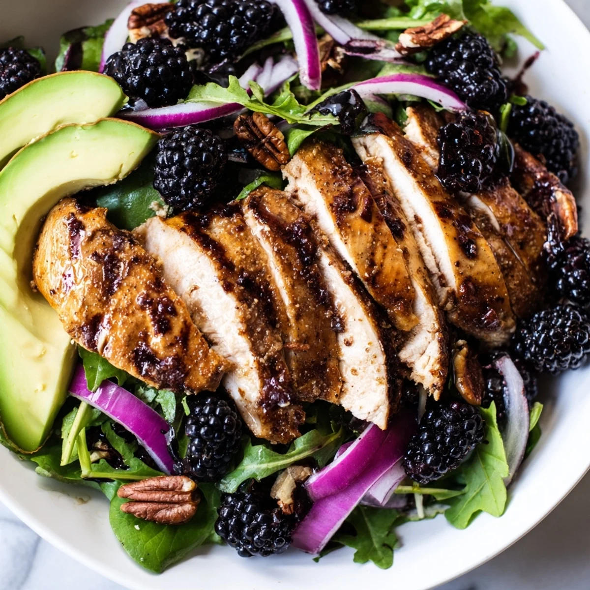Sweet Tangy Blackberry Chicken Salad on mixed greens with sliced grilled chicken