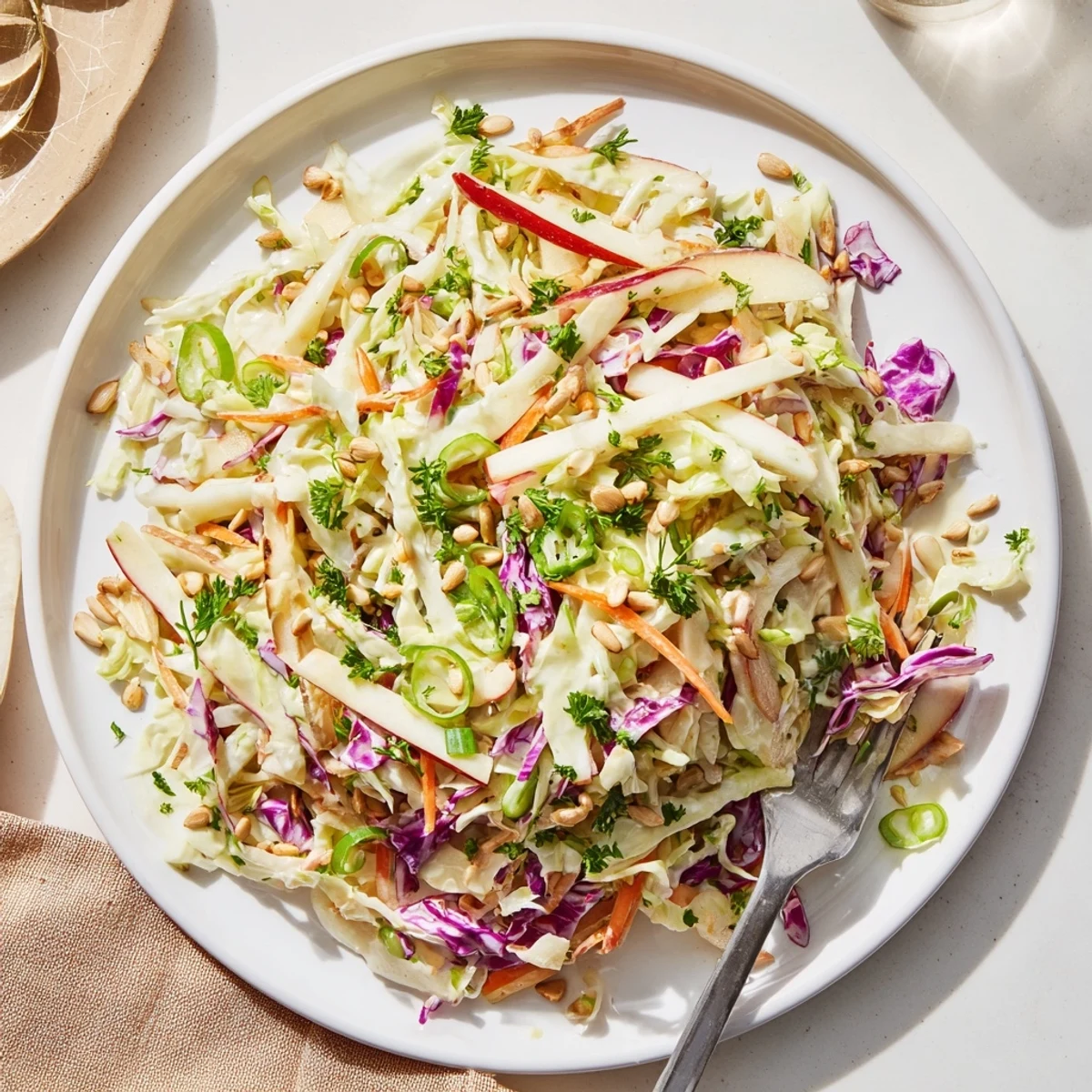 Refreshing apple coleslaw side dish with colorful red and green cabbage tossed in creamy dressing