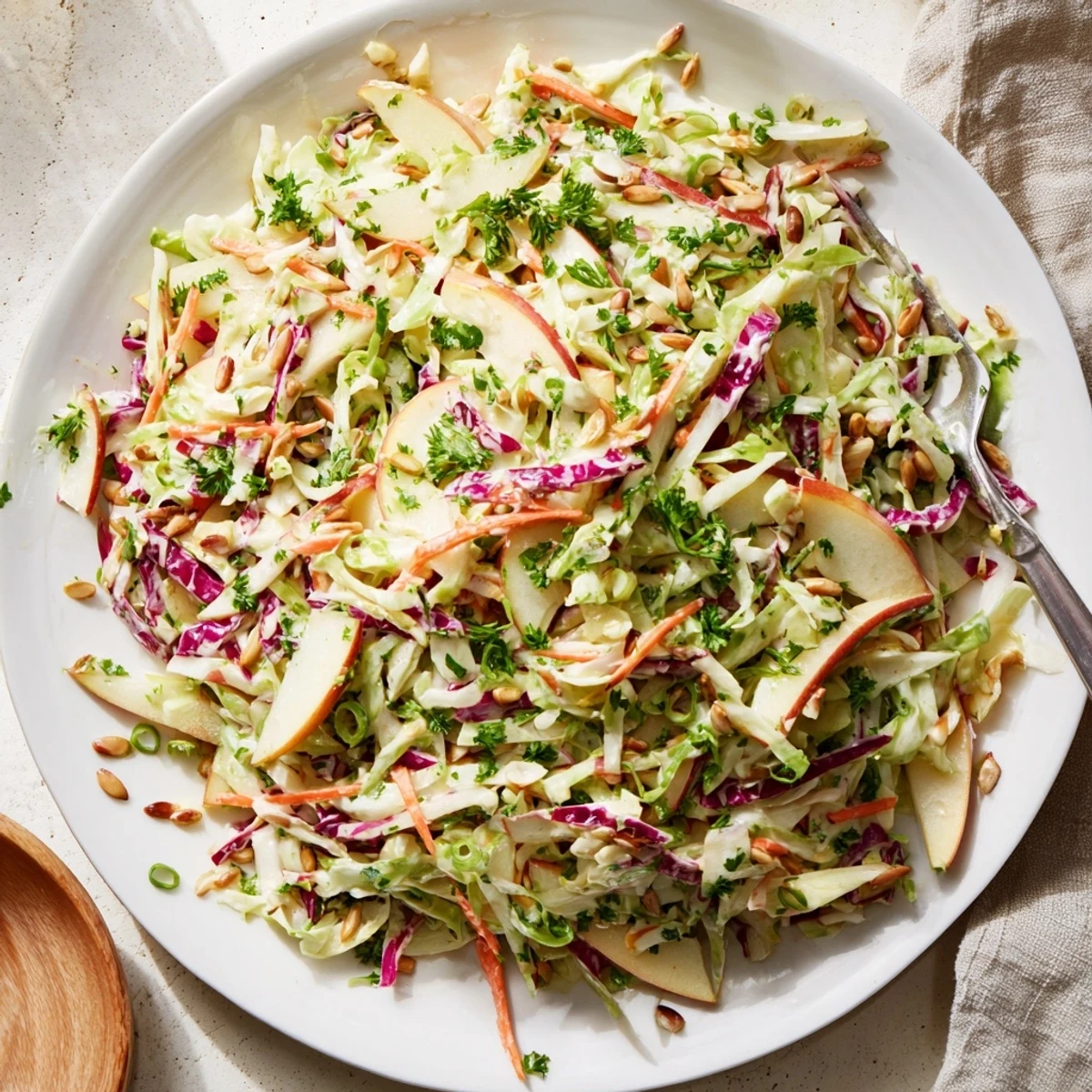 Vibrant homemade apple coleslaw with shredded green cabbage and crisp julienned Gala apples