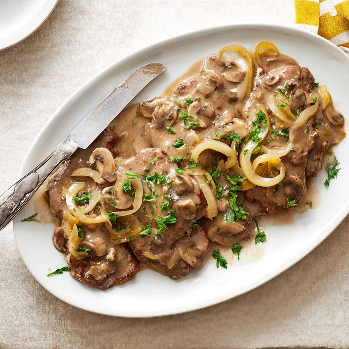 Hearty Southern cube steak plated with creamy mushroom gravy and fresh parsley garnish