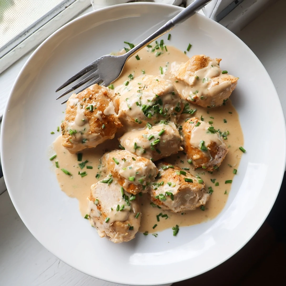 Juicy pan-seared chicken nestled in a velvety Boursin herb sauce with roasted potatoes