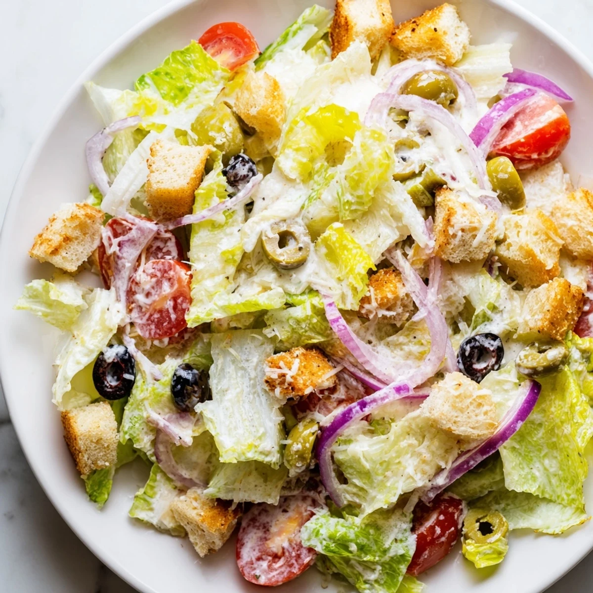Bright and tangy Olive Garden Salad featuring pepperoncini, red onions, and signature dressing