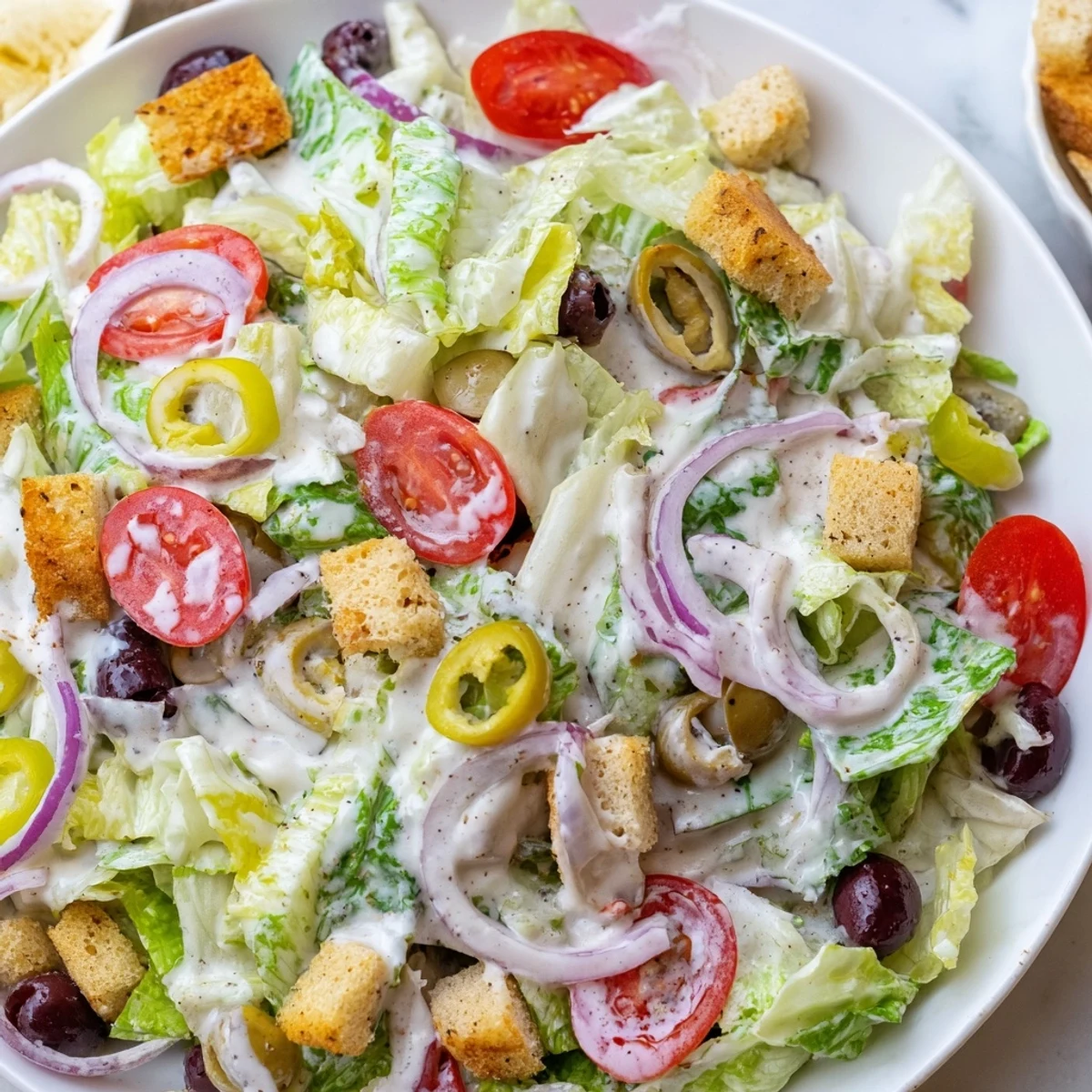 Fresh Olive Garden Salad in a bowl with crunchy croutons and grated Parmesan