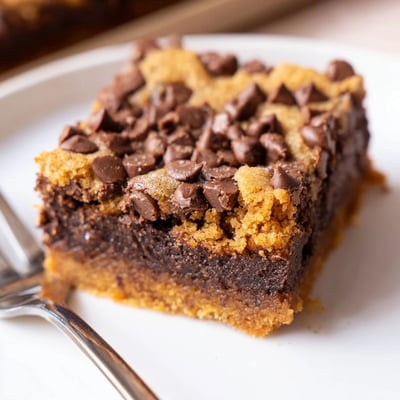 Slice of Fudgy Chewy Brookies Recipe served warm with vanilla ice cream.