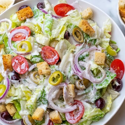 Fresh Olive Garden Salad in a bowl with crunchy croutons and grated Parmesan